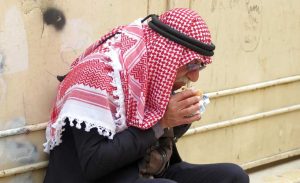 Visit Israel - Palestinian man with red and white head shawl eating his lunch