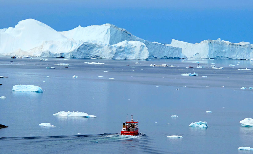 Boat heading towards icebergs